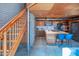 Modern staircase and kitchen with stainless steel appliances, hardwood ceilings, and wood cabinets at 920 S Ash Ave, Tempe, AZ 85281