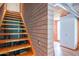 Modern staircase with hardwood steps and unique brick wall design at 920 S Ash Ave, Tempe, AZ 85281