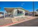 Charming single story home featuring covered parking, a well-manicured yard, and mature palm trees at 9828 E Pueblo Ave # 113, Mesa, AZ 85208