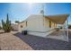 Exterior shot of well maintained home with gravel yard and cactus near a covered patio at 9828 E Pueblo Ave # 113, Mesa, AZ 85208