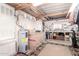 Spacious garage/workshop with water heater, overhead lighting, pegboard tools, and large storage area at 9828 E Pueblo Ave # 113, Mesa, AZ 85208