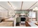 Traditional style kitchen with tile backsplash, neutral countertops, modern appliances, and an adjoining dining area at 9828 E Pueblo Ave # 113, Mesa, AZ 85208