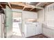 Bright laundry room features a washer, dryer, overhead storage and exterior exit to carport at 9828 E Pueblo Ave # 113, Mesa, AZ 85208