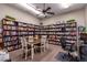 Cozy library with extensive bookshelves, a table with chairs, and a computer desk at 9828 E Pueblo Ave # 113, Mesa, AZ 85208