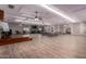 Spacious community room with hardwood-style floors, tables, chairs, and a stage for gatherings at 9828 E Pueblo Ave # 113, Mesa, AZ 85208