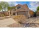 Inviting two-story home with desert landscaping and a rock drainage feature at 10676 E Acacia Dr, Scottsdale, AZ 85255