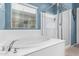 Bright bathroom with a soaking tub and a glass-enclosed shower, offering a relaxing retreat at 10746 W Desert Elm Ln, Peoria, AZ 85383