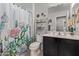 Bright bathroom showcasing a vanity with plenty of storage and stylish cactus-themed decor at 10746 W Desert Elm Ln, Peoria, AZ 85383