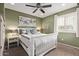 Stylish bedroom with a white bed frame, serene paint color, and ample natural light at 10746 W Desert Elm Ln, Peoria, AZ 85383