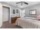 Well-designed bedroom with neutral colors, a dresser, and direct access to the ensuite bathroom at 10746 W Desert Elm Ln, Peoria, AZ 85383