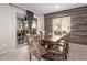 Cozy dining room featuring a wood-paneled wall, a sliding glass door, and seating for six at 10746 W Desert Elm Ln, Peoria, AZ 85383