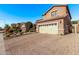 Charming two-story home featuring a spacious two-car garage, well-manicured landscaping, and a welcoming paver driveway at 10746 W Desert Elm Ln, Peoria, AZ 85383