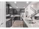 Modern kitchen featuring granite countertops, stainless steel appliances and dark wood cabinets at 10746 W Desert Elm Ln, Peoria, AZ 85383
