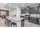 Stylish kitchen with granite countertops, stainless steel appliances, a breakfast bar, and seating for three at 10746 W Desert Elm Ln, Peoria, AZ 85383