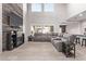 Bright, open living room with high ceilings, tile floors, a fireplace, and lots of natural light at 10746 W Desert Elm Ln, Peoria, AZ 85383
