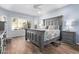 Spacious main bedroom with wood floors, a large bed, and large windows at 10746 W Desert Elm Ln, Peoria, AZ 85383