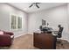 Well-lit home office featuring wood floors, neutral walls, and a large window with shutters at 10746 W Desert Elm Ln, Peoria, AZ 85383