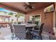 Inviting covered patio with dining area, ceiling fan, and outdoor decorations at 10746 W Desert Elm Ln, Peoria, AZ 85383