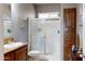 Bathroom featuring a sink, toilet, and shower with glass doors at 11596 W Sierra Dawn Blvd # 293, Surprise, AZ 85378