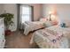 Inviting bedroom with twin beds, plant, and ample natural light at 11596 W Sierra Dawn Blvd # 293, Surprise, AZ 85378