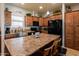 A well-lit kitchen showcasing a center island with seating, stainless steel sink, and dark appliances at 11596 W Sierra Dawn Blvd # 293, Surprise, AZ 85378