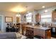 Open-concept kitchen and dining area featuring warm wood cabinetry and island seating at 11596 W Sierra Dawn Blvd # 293, Surprise, AZ 85378