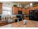 A bright kitchen with a stainless steel sink, granite countertops, and ample cabinet space at 11596 W Sierra Dawn Blvd # 293, Surprise, AZ 85378