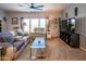A well-lit living room offers a ceiling fan, comfortable sofa, cozy chair and neutral decor at 11596 W Sierra Dawn Blvd # 293, Surprise, AZ 85378