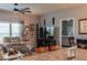 A cozy living room features comfortable seating, a ceiling fan, and neutral wall color at 11596 W Sierra Dawn Blvd # 293, Surprise, AZ 85378