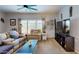Cozy living room featuring a large window, ceiling fan and comfortable seating for relaxing at 11596 W Sierra Dawn Blvd # 293, Surprise, AZ 85378