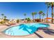 Community pool area with inviting blue waters, palm trees and lounge chairs for sunny relaxation and recreation at 11596 W Sierra Dawn Blvd # 293, Surprise, AZ 85378