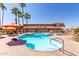 Sparkling community pool with palm trees and comfortable lounge seating, perfect for relaxation and enjoying the scenery at 11596 W Sierra Dawn Blvd # 293, Surprise, AZ 85378