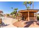 Charming poolside cabana with seating, offering shade and relaxation by the pool with desert landscaping and palm trees at 11596 W Sierra Dawn Blvd # 293, Surprise, AZ 85378