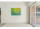 Bright room with tile floors, large sliding glass doors, and a white wall with colorful artwork at 1433 E Indian Wells Dr, Chandler, AZ 85249