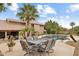 Beautiful backyard with a pool, patio, palm trees and outdoor seating area for relaxation at 15755 E Palomino Blvd, Fountain Hills, AZ 85268