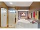 Bright bathroom features a glass-enclosed shower, a soaking tub, and neutral earth tone decor at 15755 E Palomino Blvd, Fountain Hills, AZ 85268
