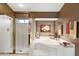 Bright bathroom features a glass-enclosed shower, a soaking tub, and neutral earth tone decor at 15755 E Palomino Blvd, Fountain Hills, AZ 85268