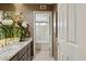 Bathroom vanity with granite counters, fresh flowers, and view to bathtub with shower at 15755 E Palomino Blvd, Fountain Hills, AZ 85268