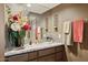 Bathroom vanity with granite counters, fresh flowers, and stylish lighting fixtures at 15755 E Palomino Blvd, Fountain Hills, AZ 85268