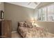 Cozy bedroom features soft natural light from shuttered window, neutral palette, and comfortable bed at 15755 E Palomino Blvd, Fountain Hills, AZ 85268