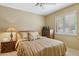 Bedroom with light neutral color, furnishings, and bright, natural sunlight from shuttered window at 15755 E Palomino Blvd, Fountain Hills, AZ 85268