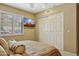 Cozy bedroom with a window with shutters, a mounted television, and a closet with paneled doors at 15755 E Palomino Blvd, Fountain Hills, AZ 85268