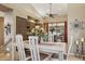 Dining room featuring white table with chairs, brown cabinets, and patio access at 15755 E Palomino Blvd, Fountain Hills, AZ 85268