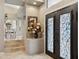 Elegant foyer featuring decorative iron doors, tile flooring, and a view into the dining area at 15755 E Palomino Blvd, Fountain Hills, AZ 85268