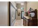 Hallway with tile flooring, framed art, and a glimpse of a decorative front door at the end at 15755 E Palomino Blvd, Fountain Hills, AZ 85268