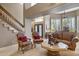 Spacious living room with elegant chairs, neutral walls, and a staircase visible in the background at 15755 E Palomino Blvd, Fountain Hills, AZ 85268