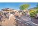 Well-maintained backyard with a built-in BBQ, patio, and desert landscaping at 16292 N Naegel Dr, Surprise, AZ 85374