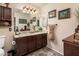 Well-lit bathroom featuring a granite countertop vanity and decorative accents at 16292 N Naegel Dr, Surprise, AZ 85374