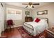 Cozy bedroom featuring a metal bed frame, decorative rug, and a ceiling fan at 16292 N Naegel Dr, Surprise, AZ 85374