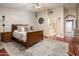 Inviting bedroom with wood flooring, neutral tones, and access to ensuite bathroom, creating a peaceful retreat at 16292 N Naegel Dr, Surprise, AZ 85374